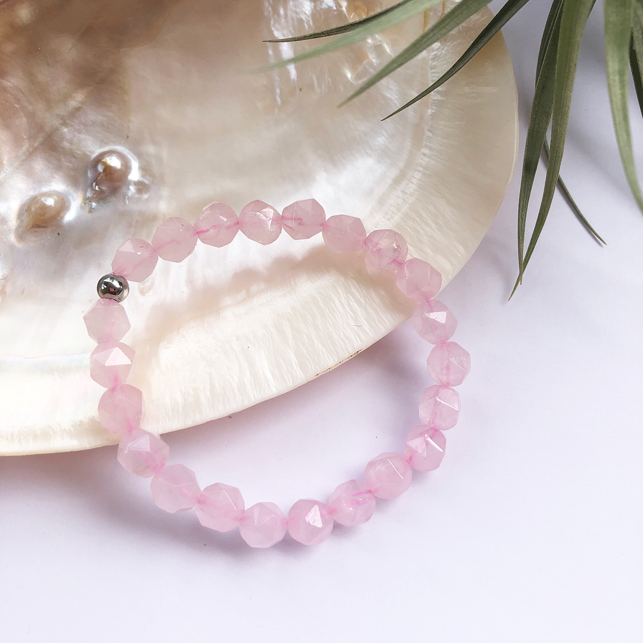 Rose Quartz Bead Bracelet on shell