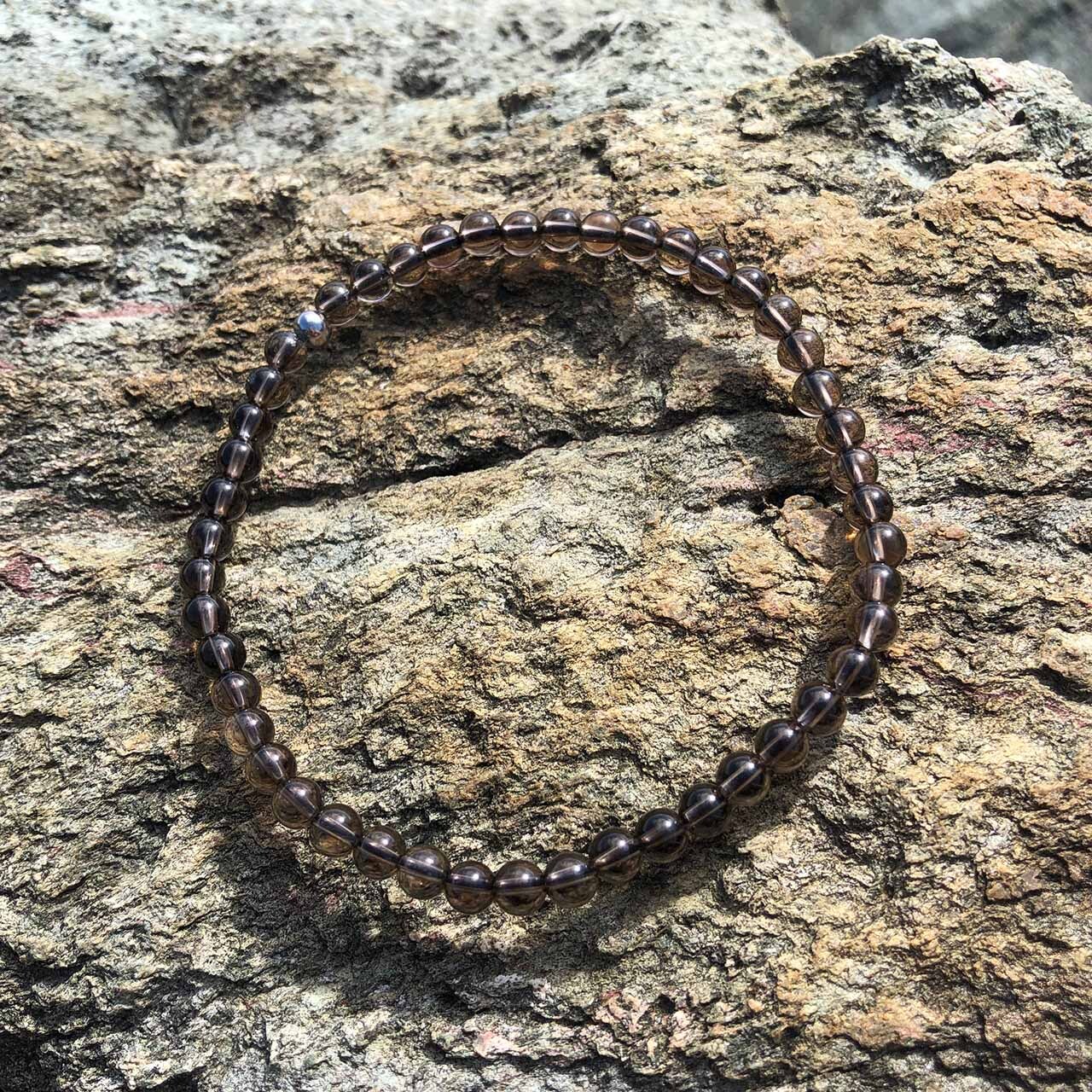 Smoky Quartz bead bracelet on rock ledge