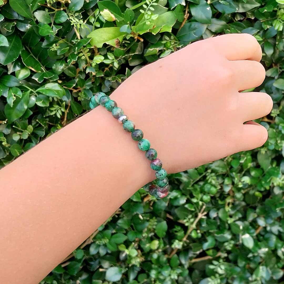 Hand wearing a Ruby in Zoisite 6mm bracelet