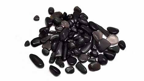 Pile of small Obsidian crystal chips on white background