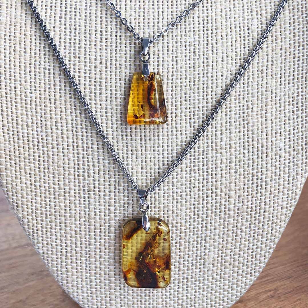 Amber Stainless Steel Pendants on beige bust