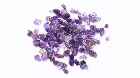 Small Amethyst Crystal Chips on white background