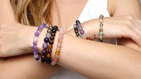 Wearing several bracelets on each arm Many bracelets on overlapping arms