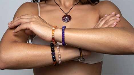 Energy dynamics of the hands Arms crossed wearing crystal bracelets