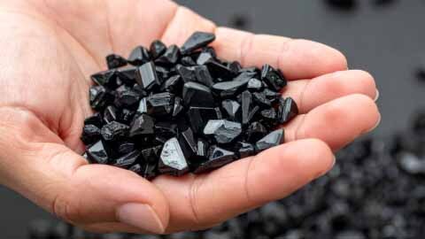 Hand holding Tourmaline crystals Hand holding Tourmaline crystals