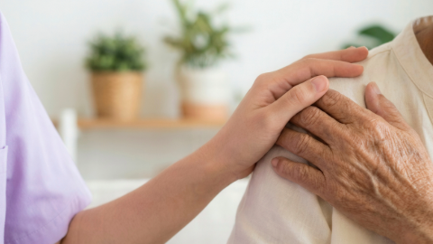 Caring hand on shoulder