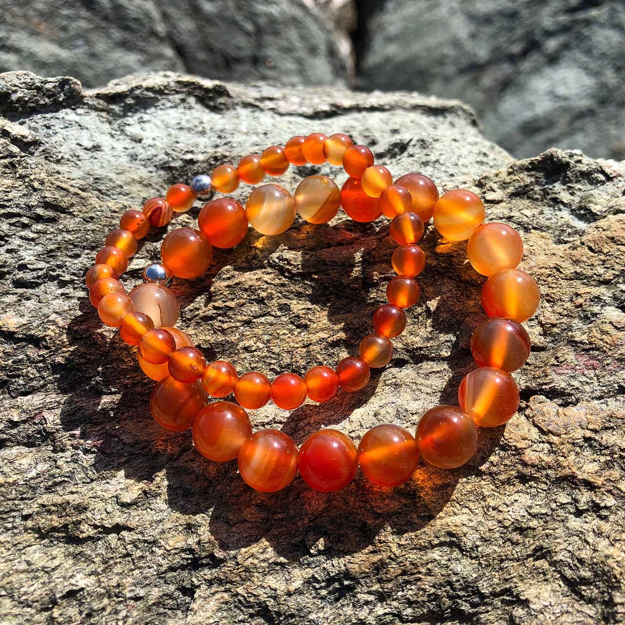 Carnelian 6mm vs 10mm resting on rockface Carnelian 6mm vs 10mm resting on rockface