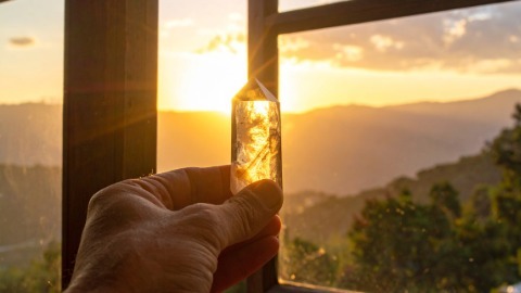 Hand holding Citrine near a window