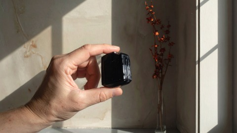 Hand Placing Tourmaline in Corner