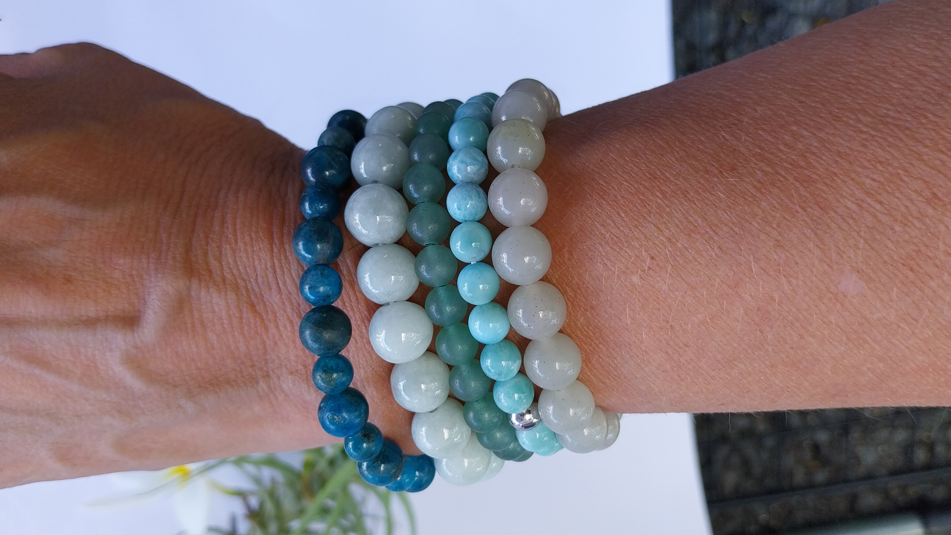 Hand wearing different bead bracelets Hand wearing different bead bracelets