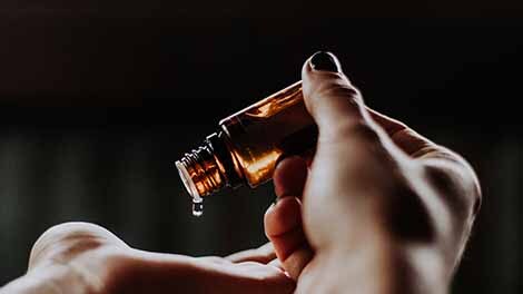 Essential Oil blend dripping on hands Essential Oil blend dripping on hands