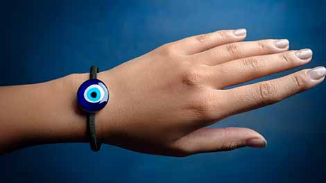 Hand with Evil Eye lampwork disc braided bracelet