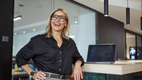 Smiling woman leaning on counter