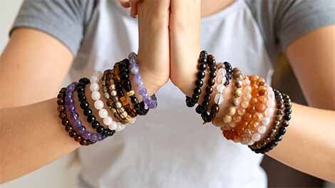 Wrists wearing many crystal bracelets Wrists wearing many crystal bracelets