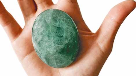 Green Palm Stone sitting in right hand