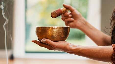 Hands Playing a Singing Bowl with smoke