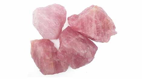 Rose Quarz rough specimens on white background